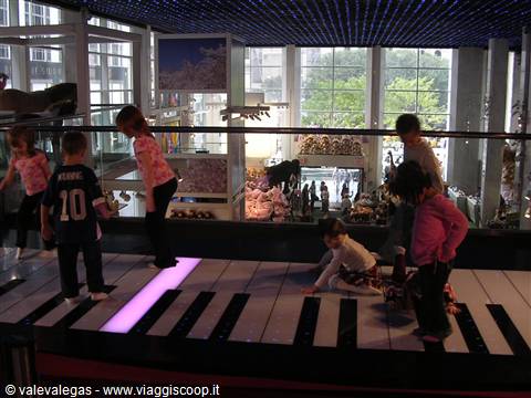 Children playing the giant lighted floor piano at FAO Schwarz, New York