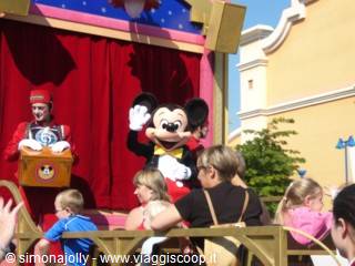 Mickey Mouse waving from a parade float at Disneyland