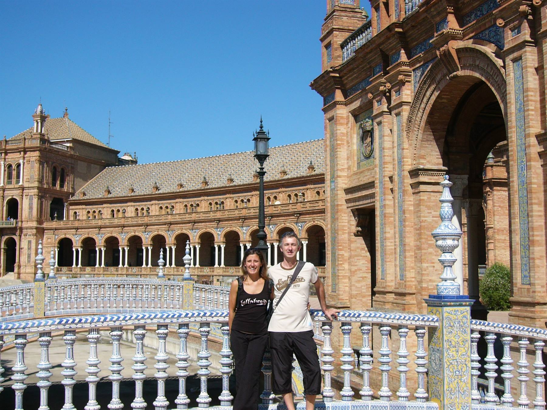 Smiling couple on the ceramic-tiled bridge, Plaza de España, Seville