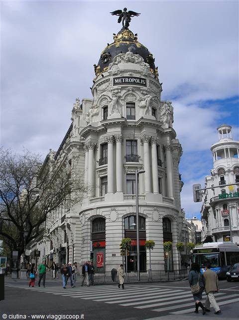 Pedestrians cross in front of the Metrópolis building in Madrid