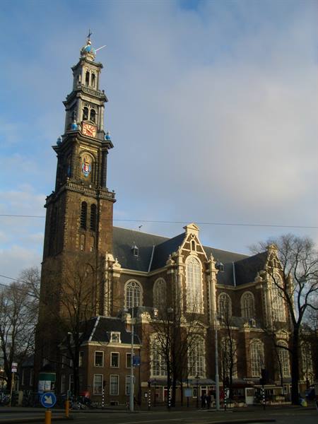Amsterdam's Westerkerk, brick tower with blue imperial crown beneath clouds