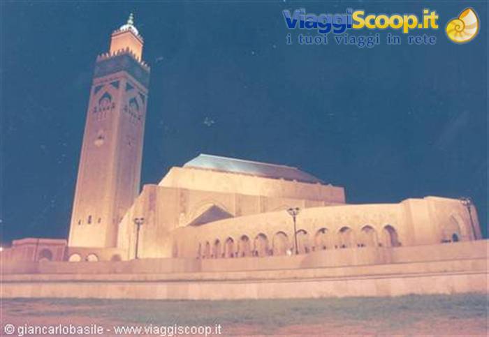 Hassan II Mosque lit at night in Casablanca, minaret and arches