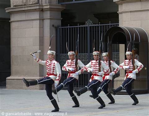 Honor guard in red and white uniform marching at Prague Castle