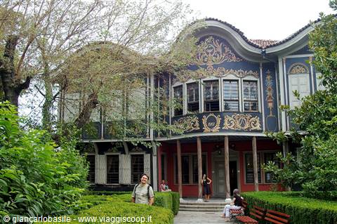 Tourist in front of the painted 19th-century building of Plovdiv ethnographic museum