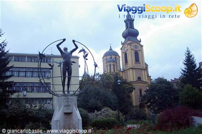 Man statue inside metal globe in front of Sarajevo Orthodox cathedral
