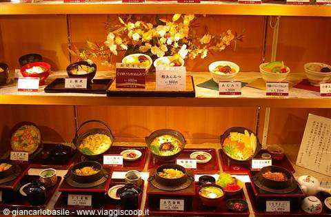 Japanese restaurant display window with wax food replicas and price lists