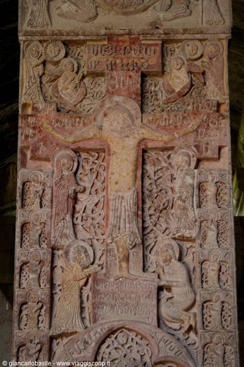 Stone relief carving of the crucified Christ with saints and Georgian inscriptions