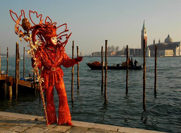 Red carnival costume in Venice, San Giorgio Maggiore in the background