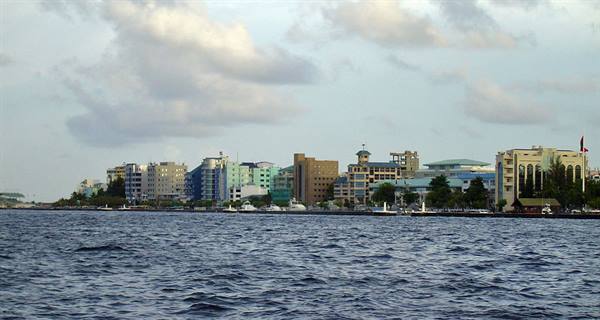 Malé skyline seen from the sea under clouds and soft light