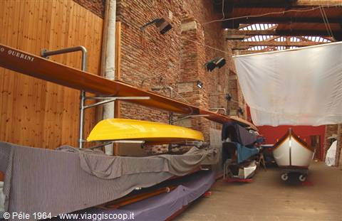 Venetian boatyard: covered gondolas and wooden oars inside the workshop