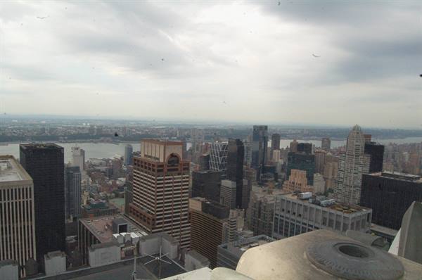 Manhattan skyscrapers under cloudy sky, the Hudson River and glass towers