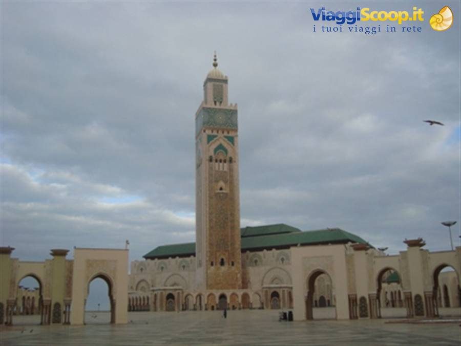 Stone arcades and the tall minaret of Hassan II Mosque in Casablanca