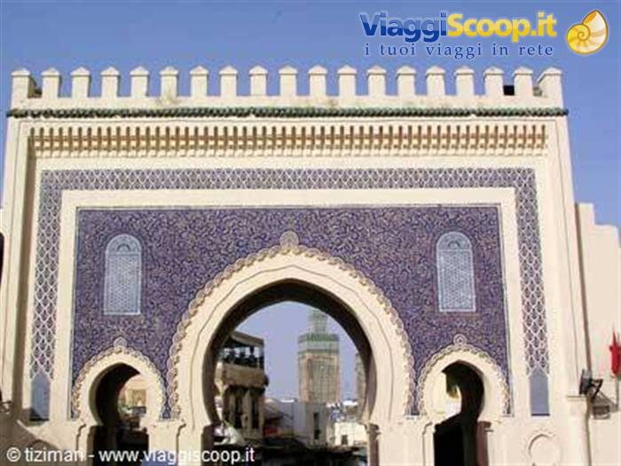 Bab Bou Jeloud gate in Fez, blue zellige tiles, minaret visible through the arch