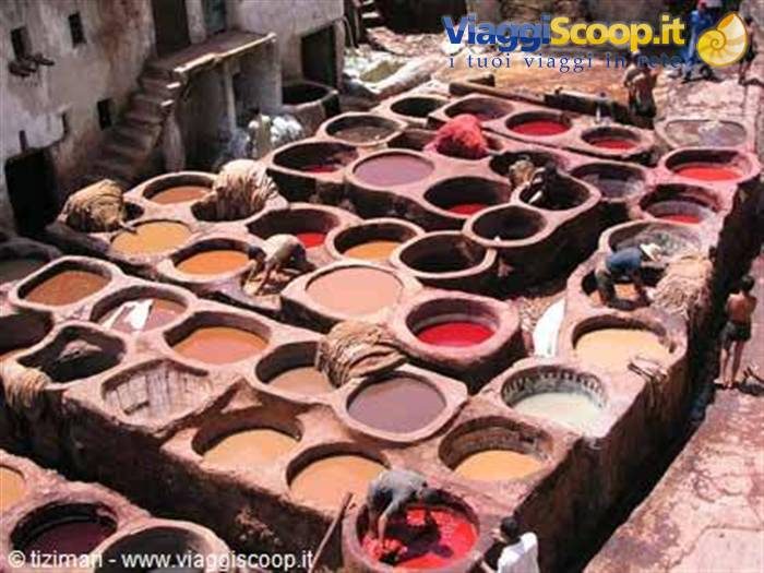 Workers tending stone vats filled with dyes at the tanneries